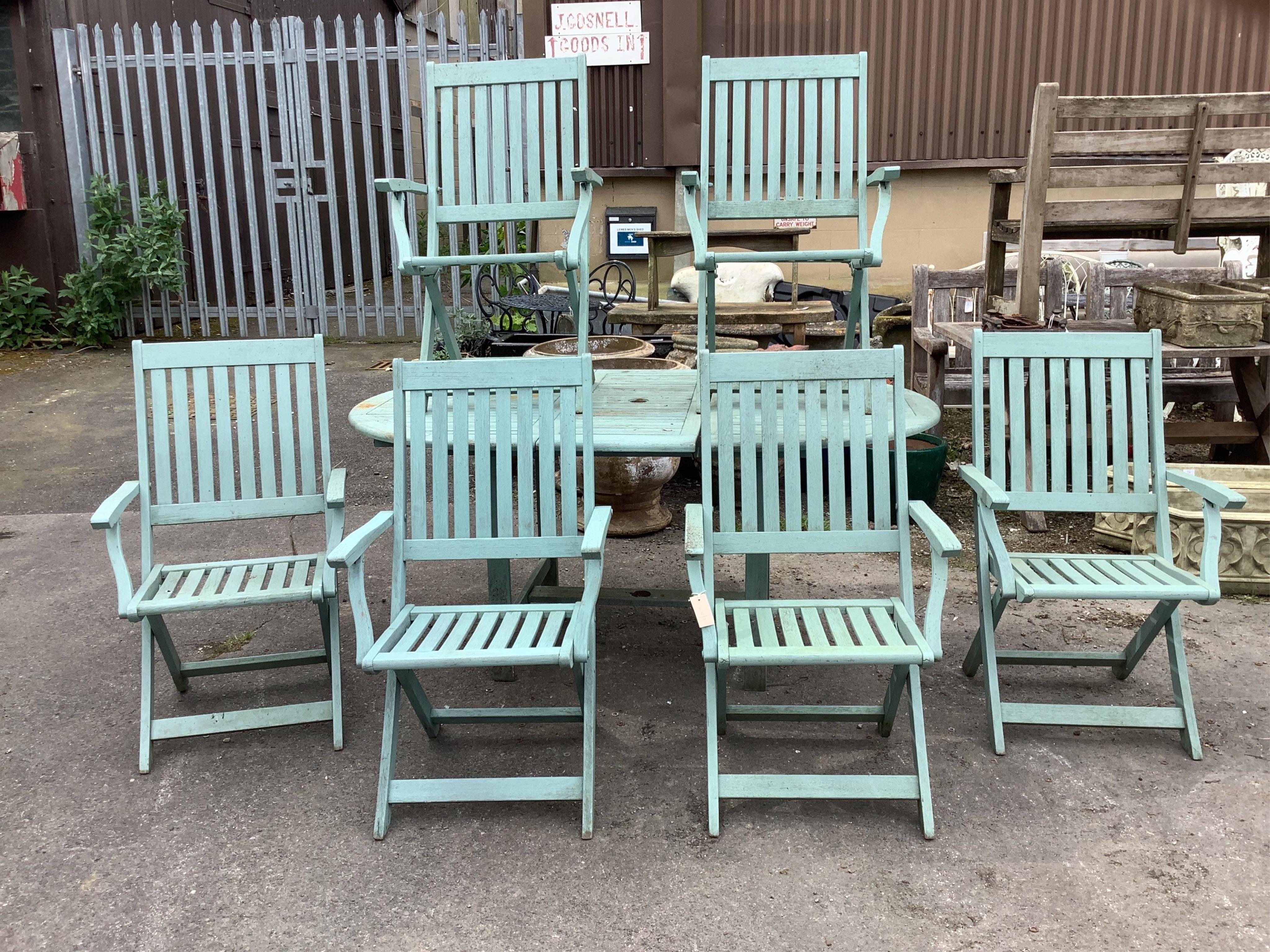 A painted teak extending garden table, width 170cm extended, depth 110cm, height 75cm together with six matching folding armchairs